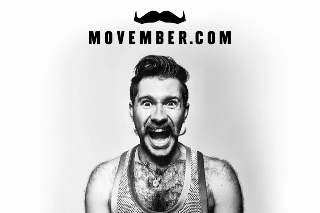 A man with a moustache, supporting Movember, with the Movember.com logotype and logo.