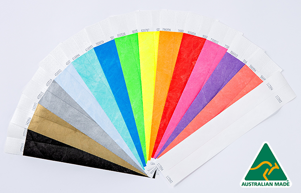 A display of assorted coloured Tyvek wristbands on a white surface.