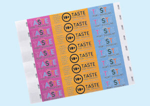 A set of full colour wristbands for a tasting event, featuring custom designs from The Wristband Co.